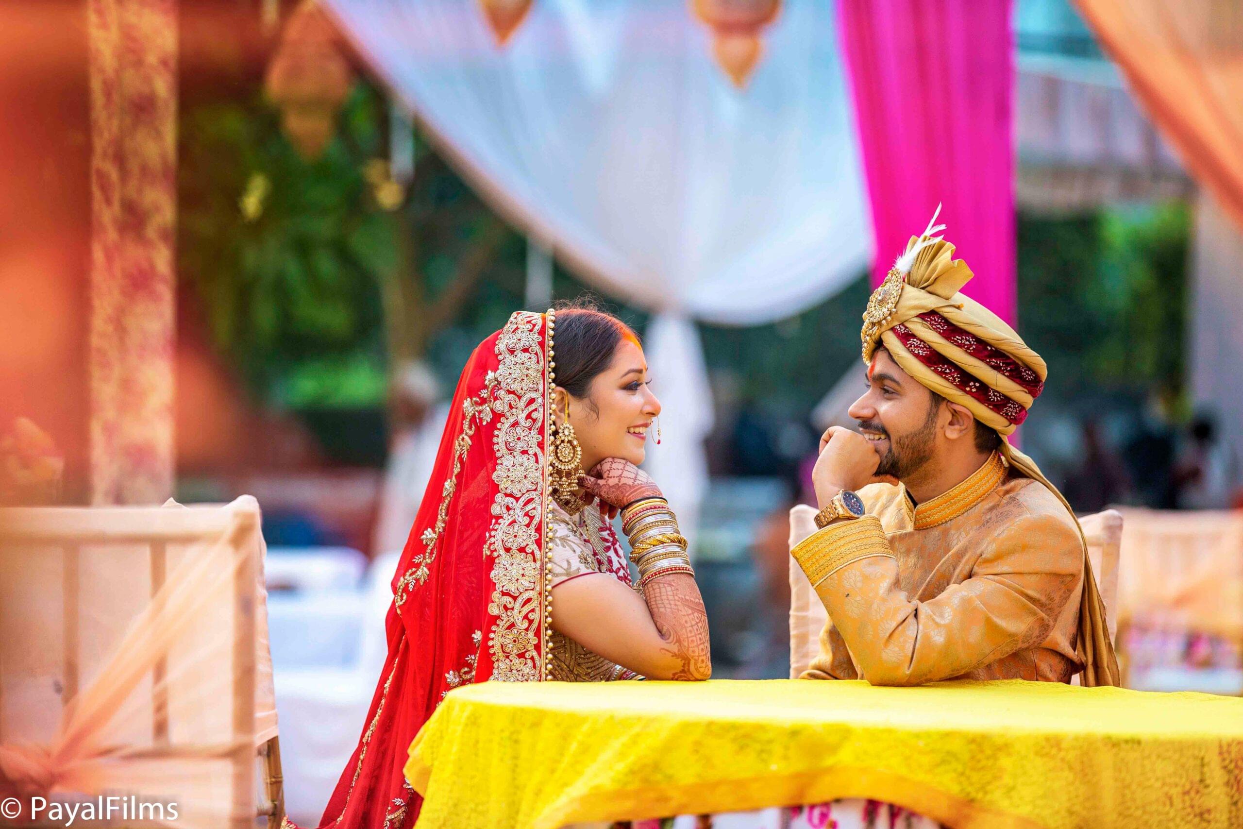 Payal Films bride and groom in regal wedding attire sharing a candid moment at Bihar ceremony